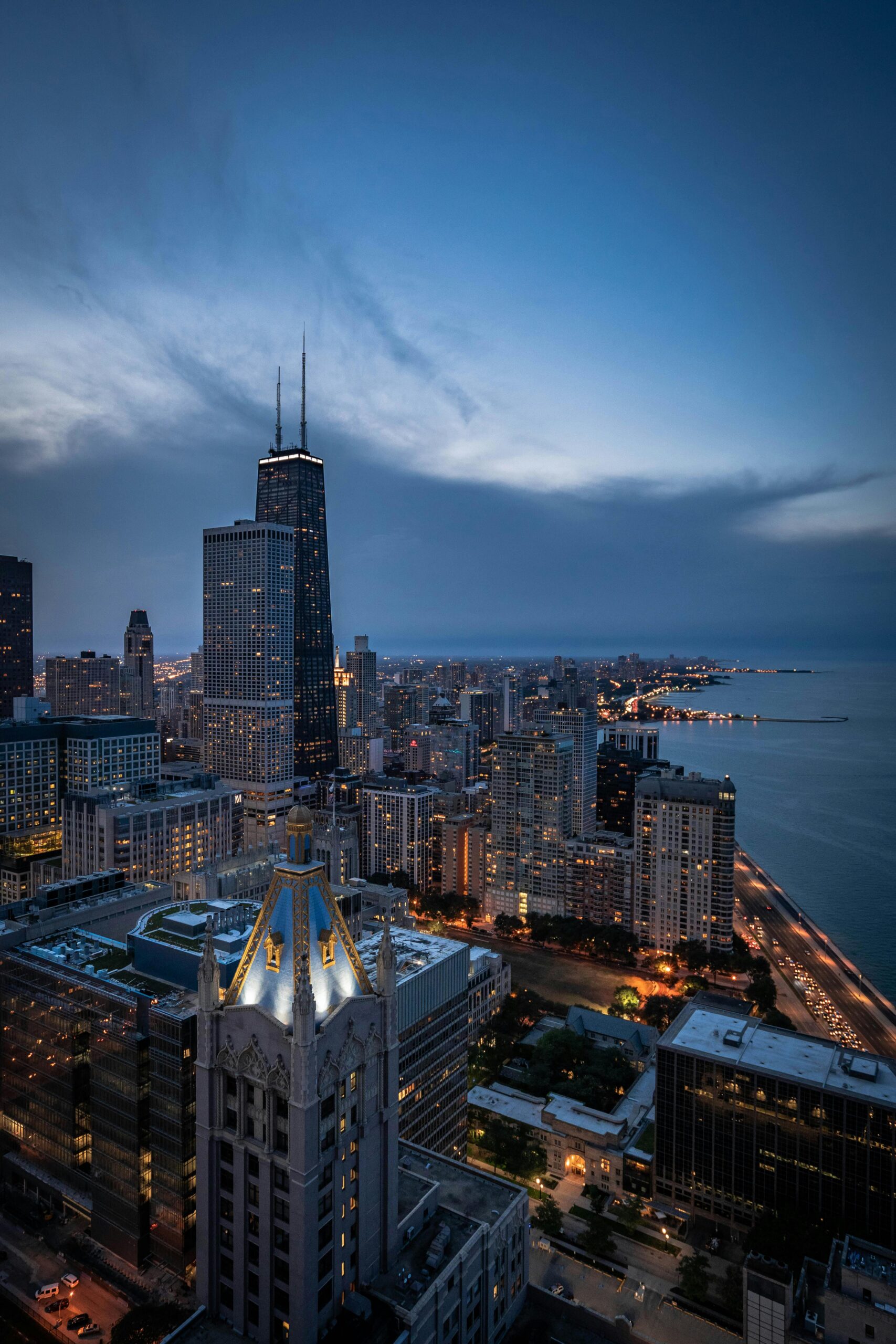 A breathtaking aerial view of Chicago's skyline featuring the iconic John Hancock Center at twilight.